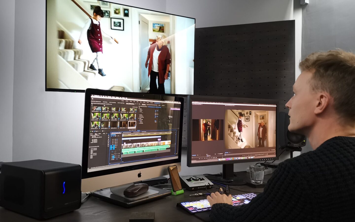 Editor in edit suite with multiple screens