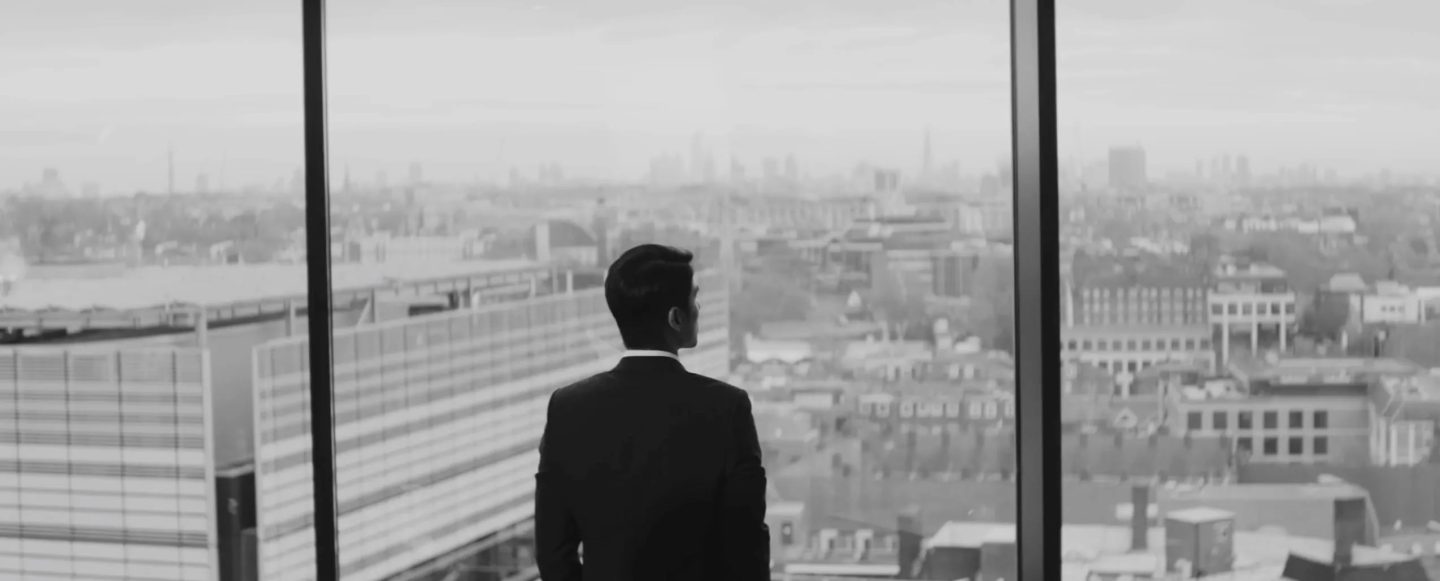 Businessman looking out of window over London skyline for a video production company in London